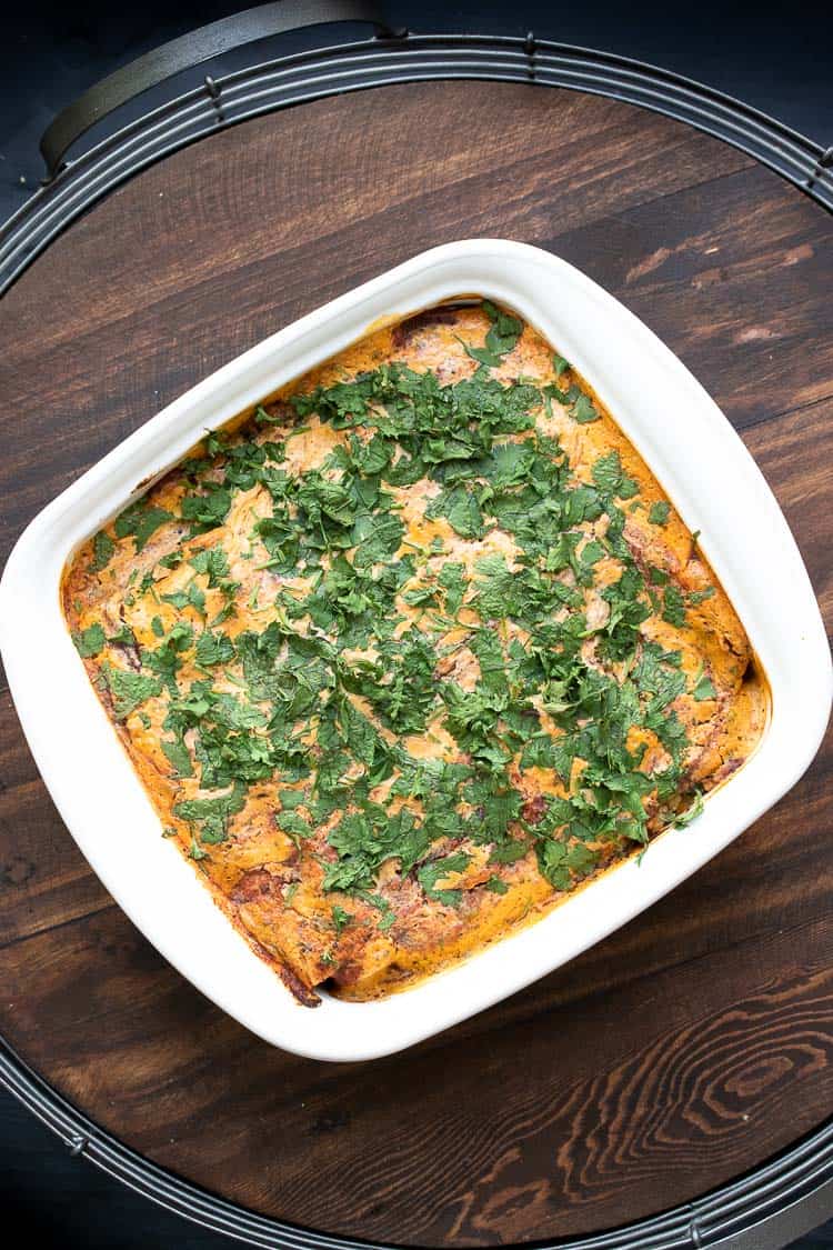 Baked chickpea and spinach enchiladas in a white baking dish