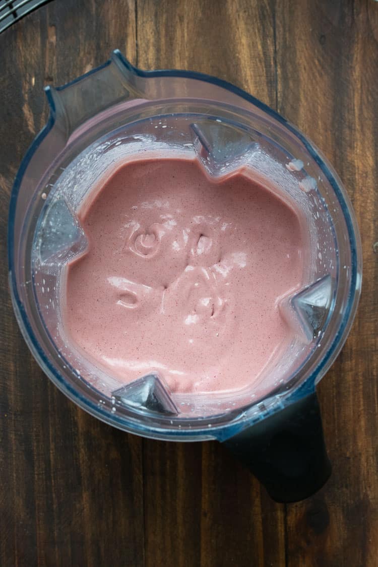 Top view of a strawberry smoothie in a blender