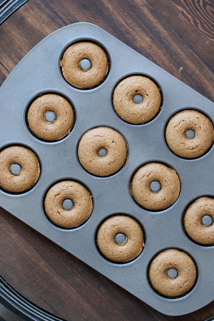 Donut pan filled with baked tan colored donuts