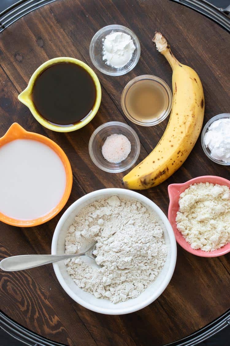 Ingredients for banana oatmeal pancakes in bowls on a wooden table