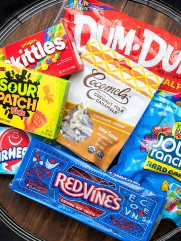 A collection of vegan candy on a wooden tray