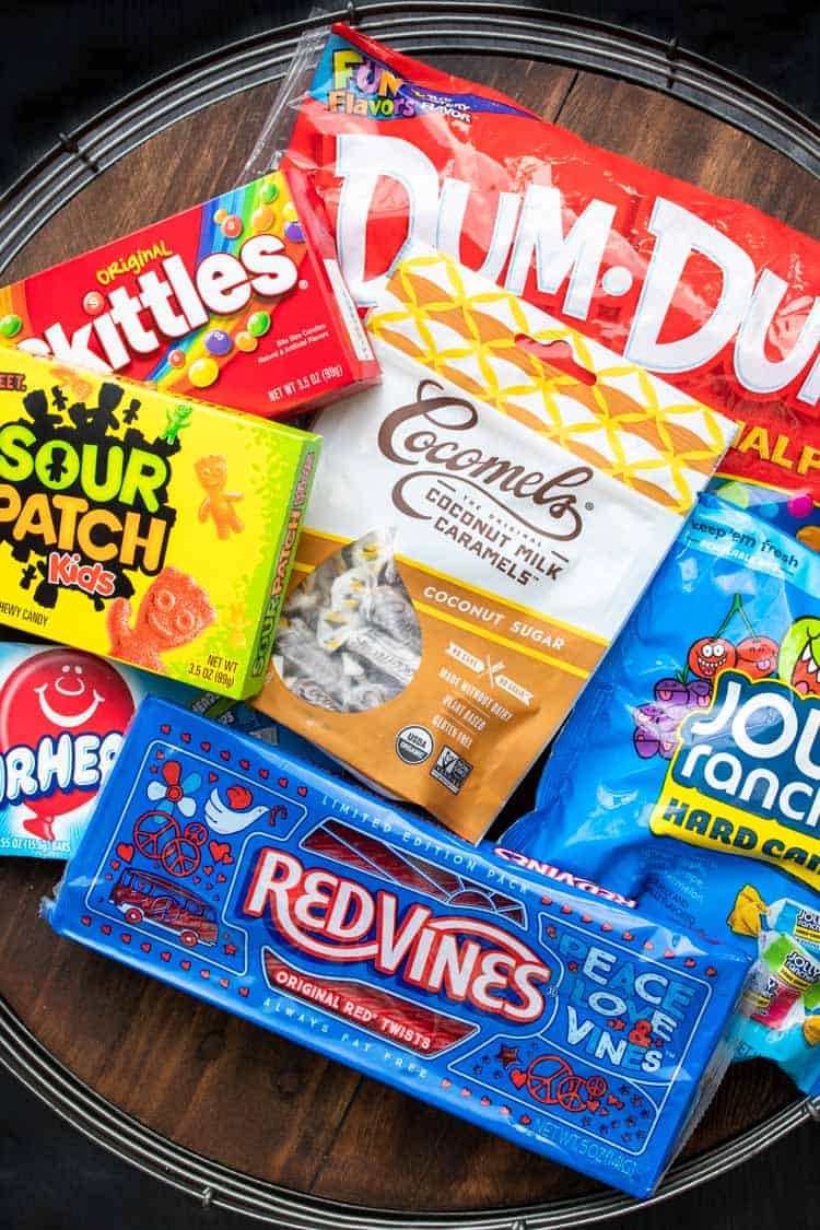 A collection of vegan candy on a wooden tray