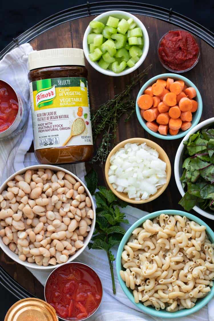 Bowls filled with ingredients for vegetable minestrone soup