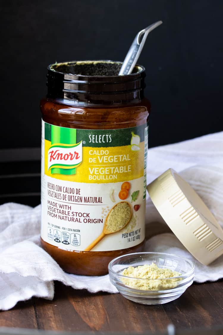 Measuring spoon in a container of vegetable bouillon by Knorr