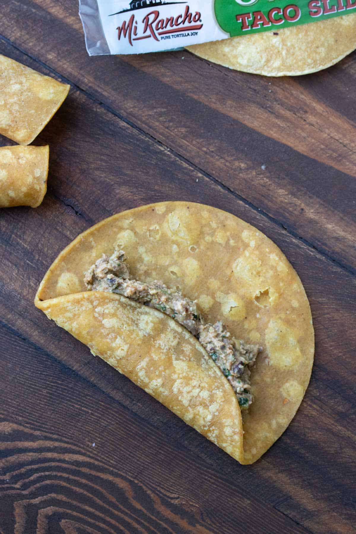 Corn tortilla with bean filling in the center and the side folded over it