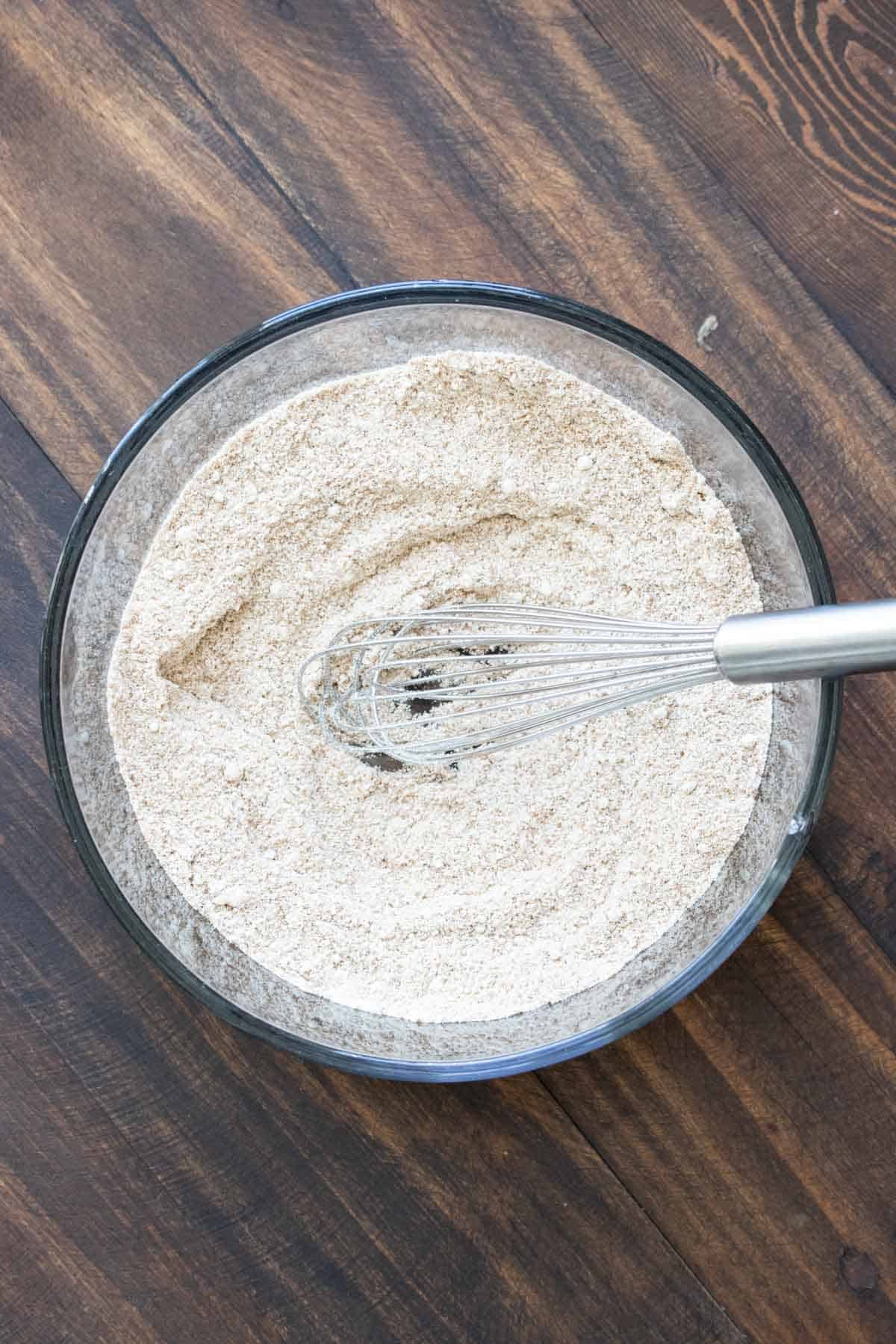 Whisk mixing flours in a glass bowl.