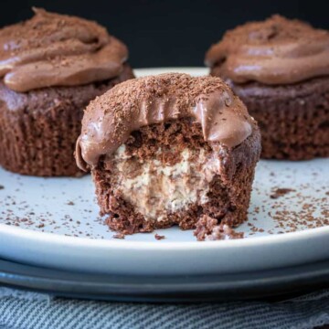 Chocolate cupcake stuffed with vanilla ice cream with a bite out of it