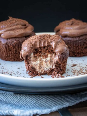 Chocolate cupcake stuffed with vanilla ice cream with a bite out of it