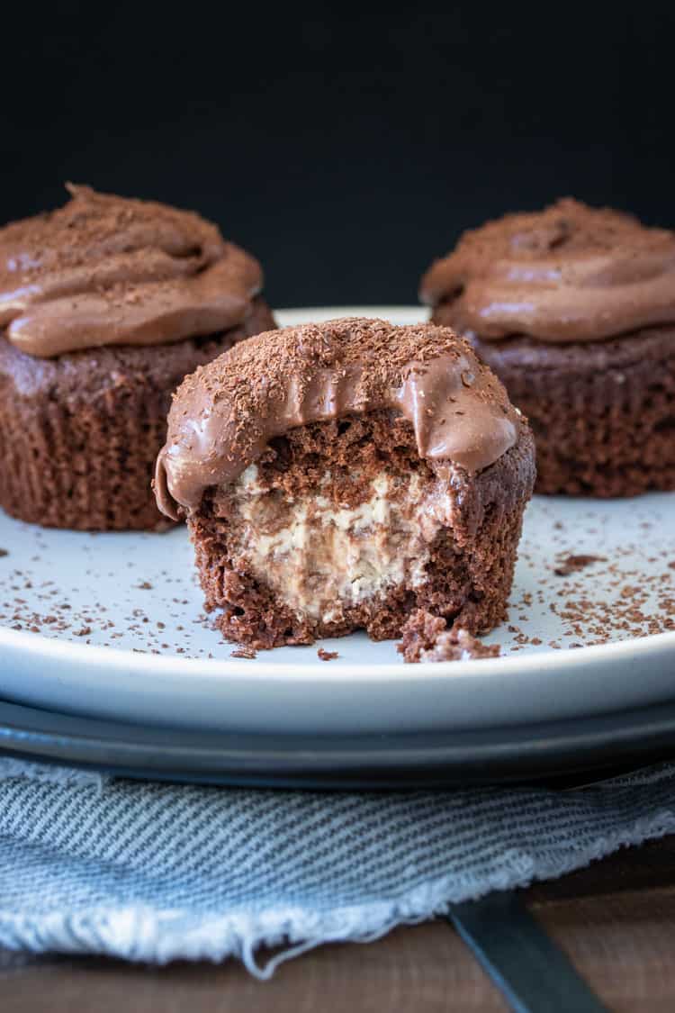 Chocolate cupcake stuffed with vanilla ice cream with a bite out of it