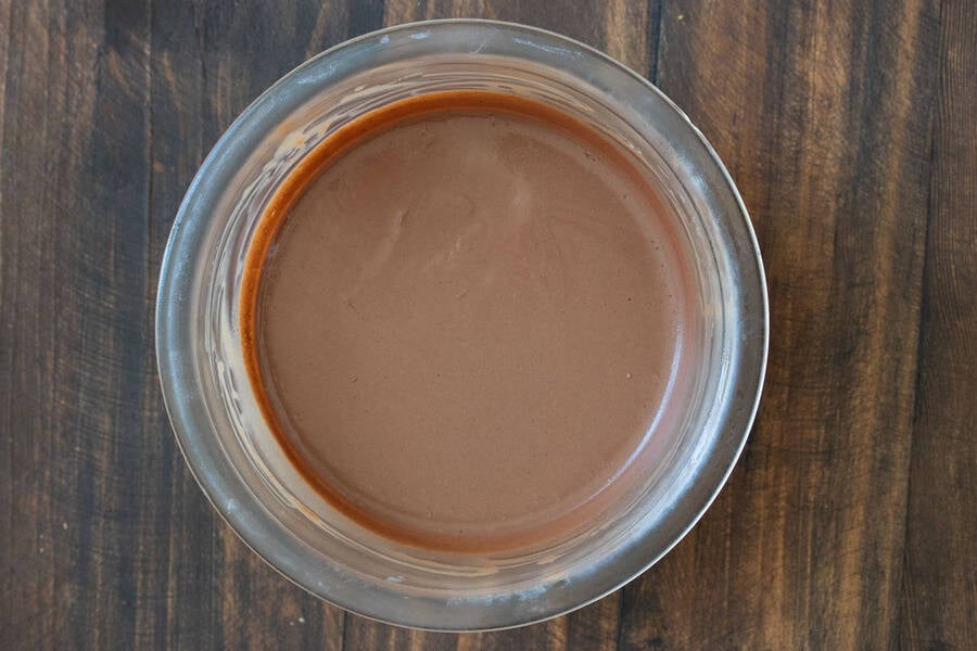 Solid smooth chocolate frosting in a glass jar