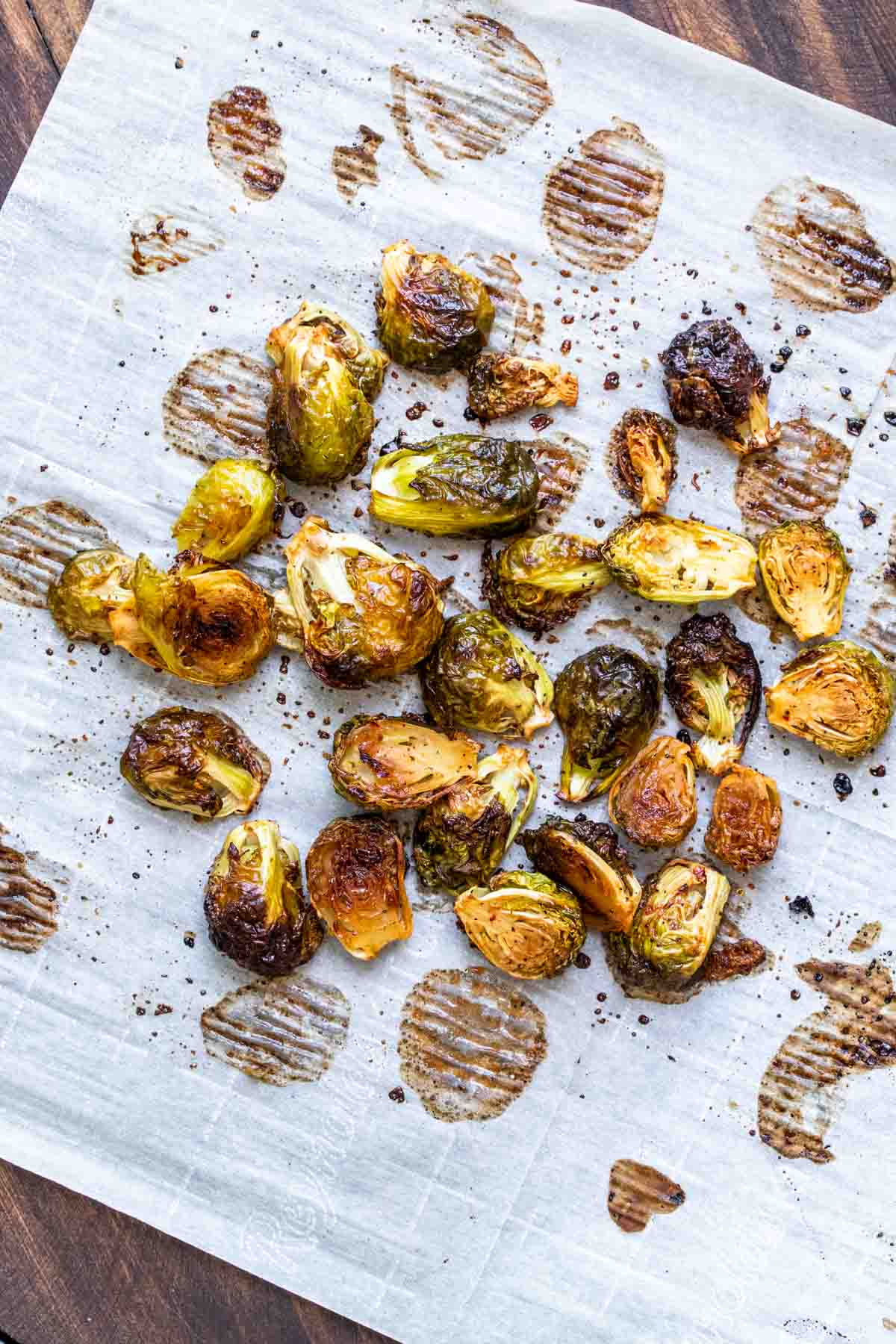 Roasted Brussels sprouts on a piece of parchment paper.