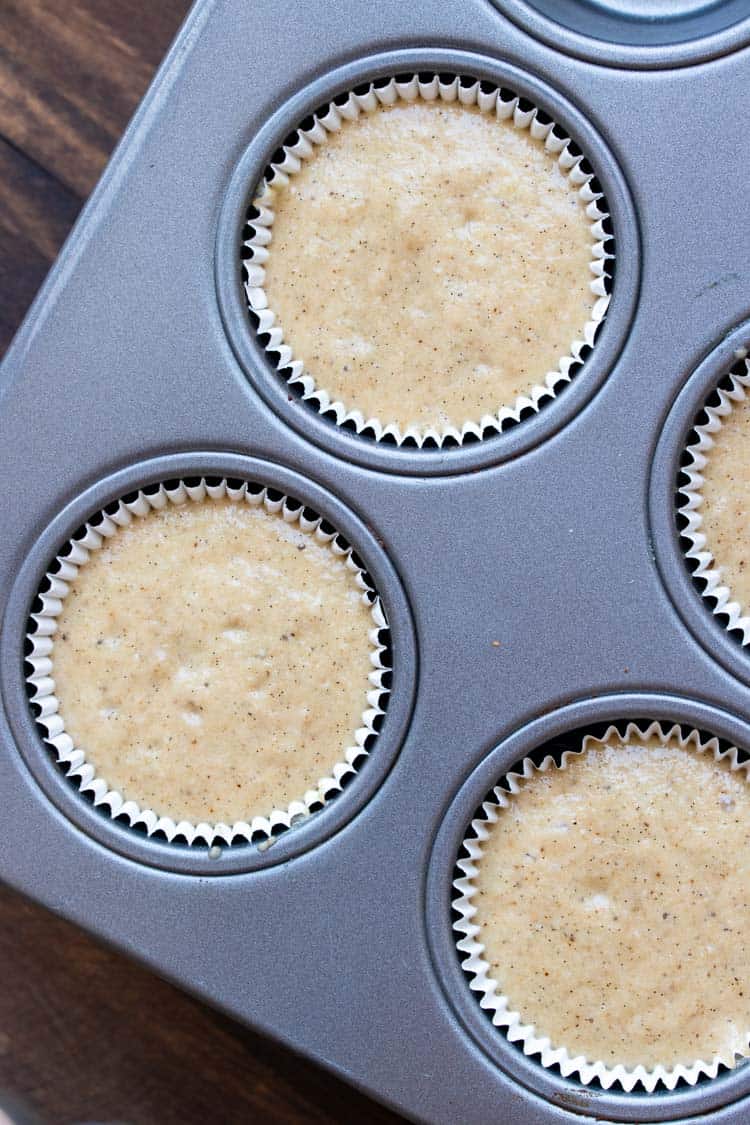 Vanilla cupcake batter in cupcake liners in a muffin pan