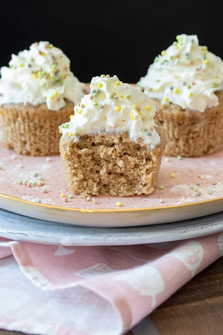 Inside texture of a vanilla bean cupcake topped with whipped cream