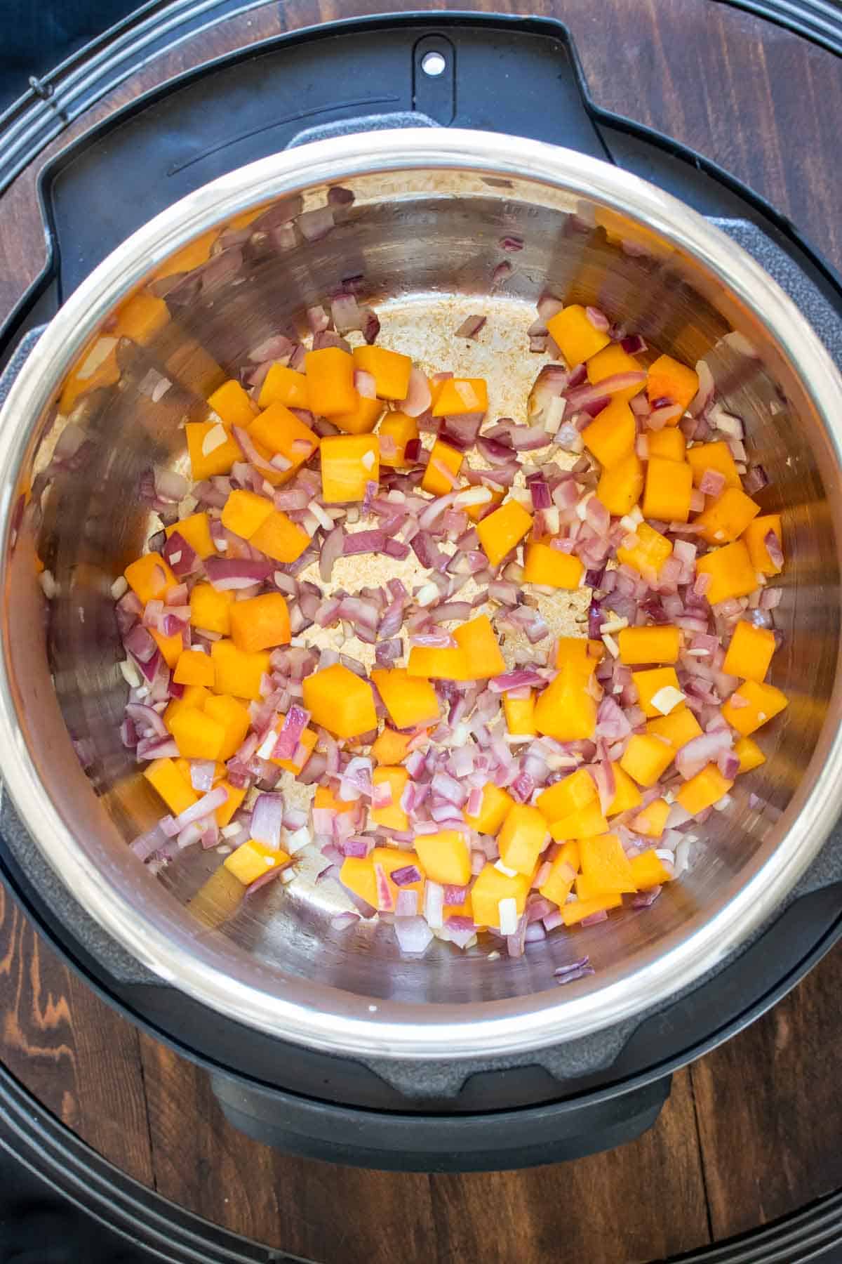 Sautéed butternut squash and red onions in a slow cooker