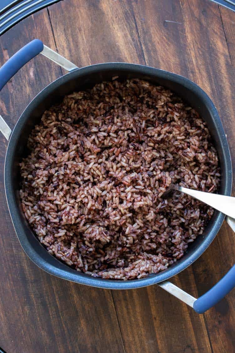 Black pot filled with a brown rice medley.