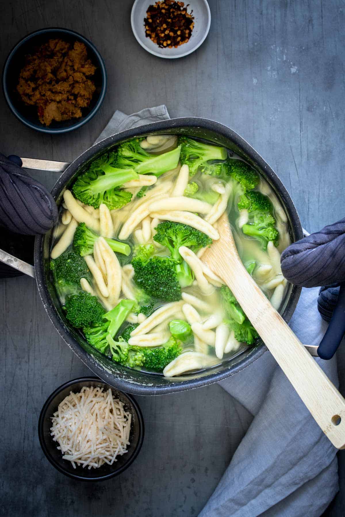 Overhead view of a pot filled with water, broccoli and pasta