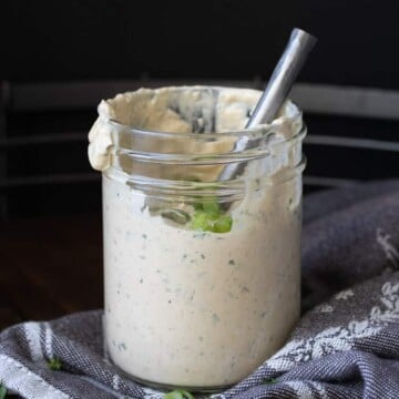 Glass jar with metal spoon in cajun remoulade