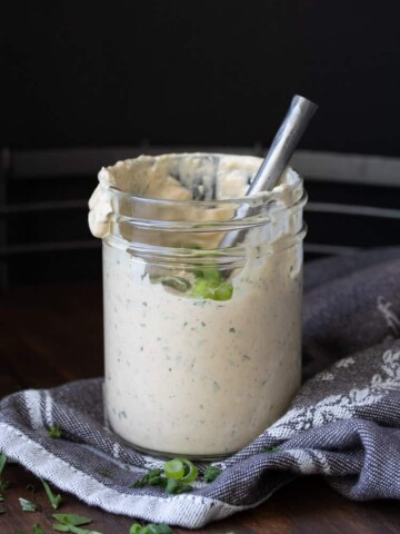 Glass jar with metal spoon in cajun remoulade