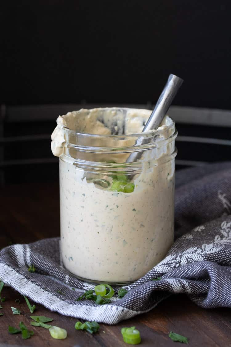 Glass jar with metal spoon in cajun remoulade