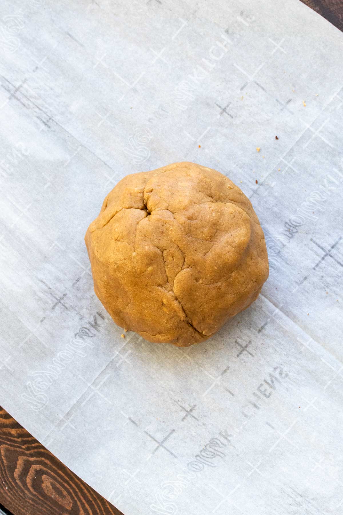 Round ball of cookie dough on a piece of parchment paper