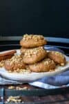 Pile of melomakarona Greek Christmas cookies on a cream plate