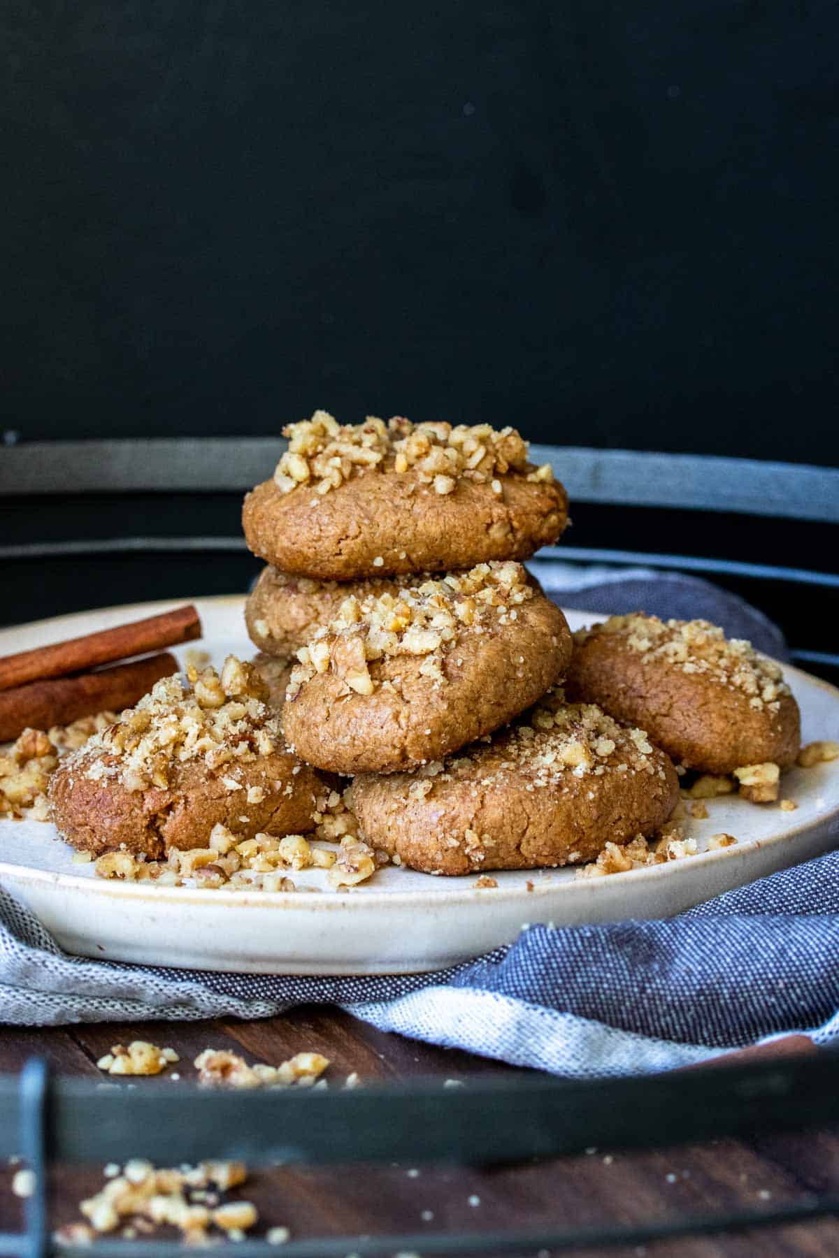 Pile of melomakarona Greek Christmas cookies on a cream plate