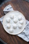 Cream plate with powdered sugar covered cookie balls