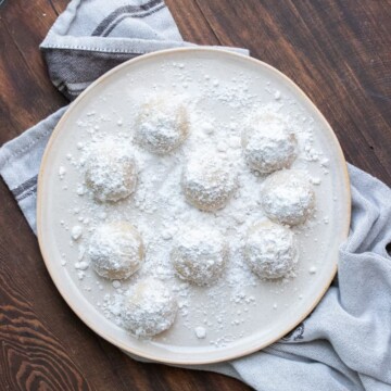 Cream plate with powdered sugar covered cookie balls