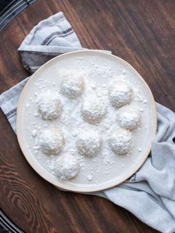 Cream plate with powdered sugar covered cookie balls