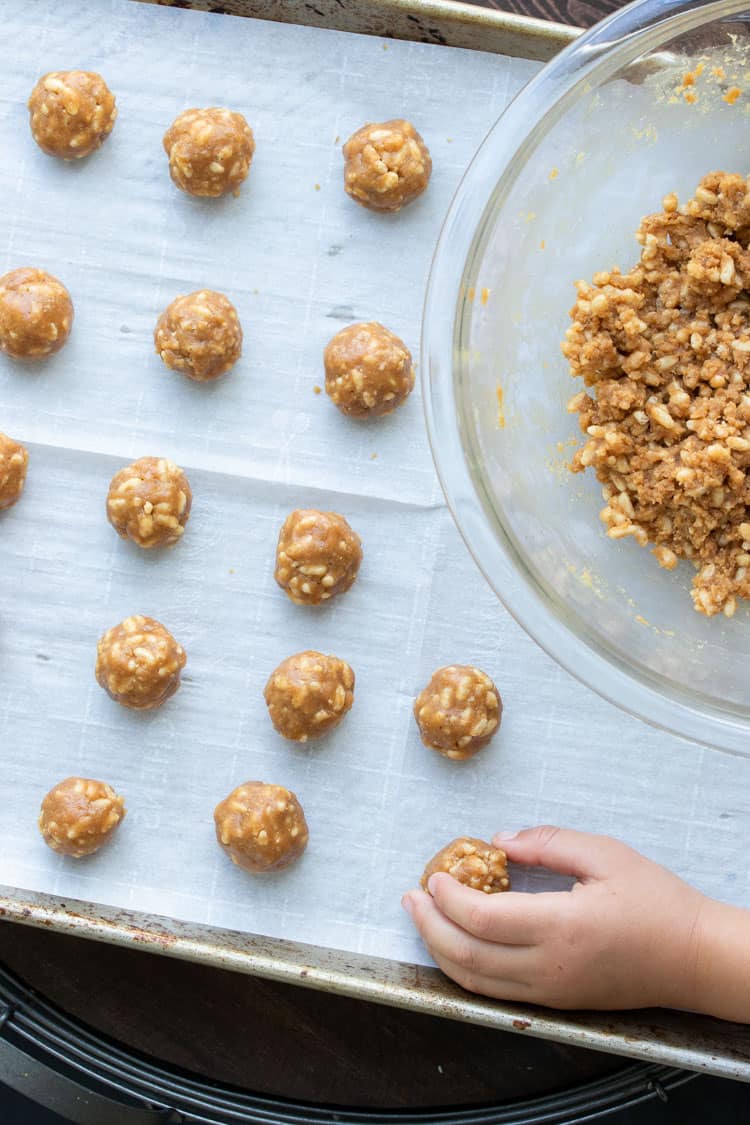 Baking sheet with peanut butter balls on it