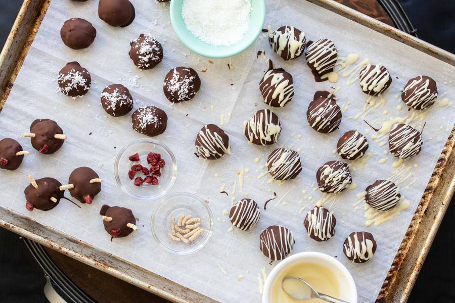 Chocolate covered peanut butter balls with different types of decor