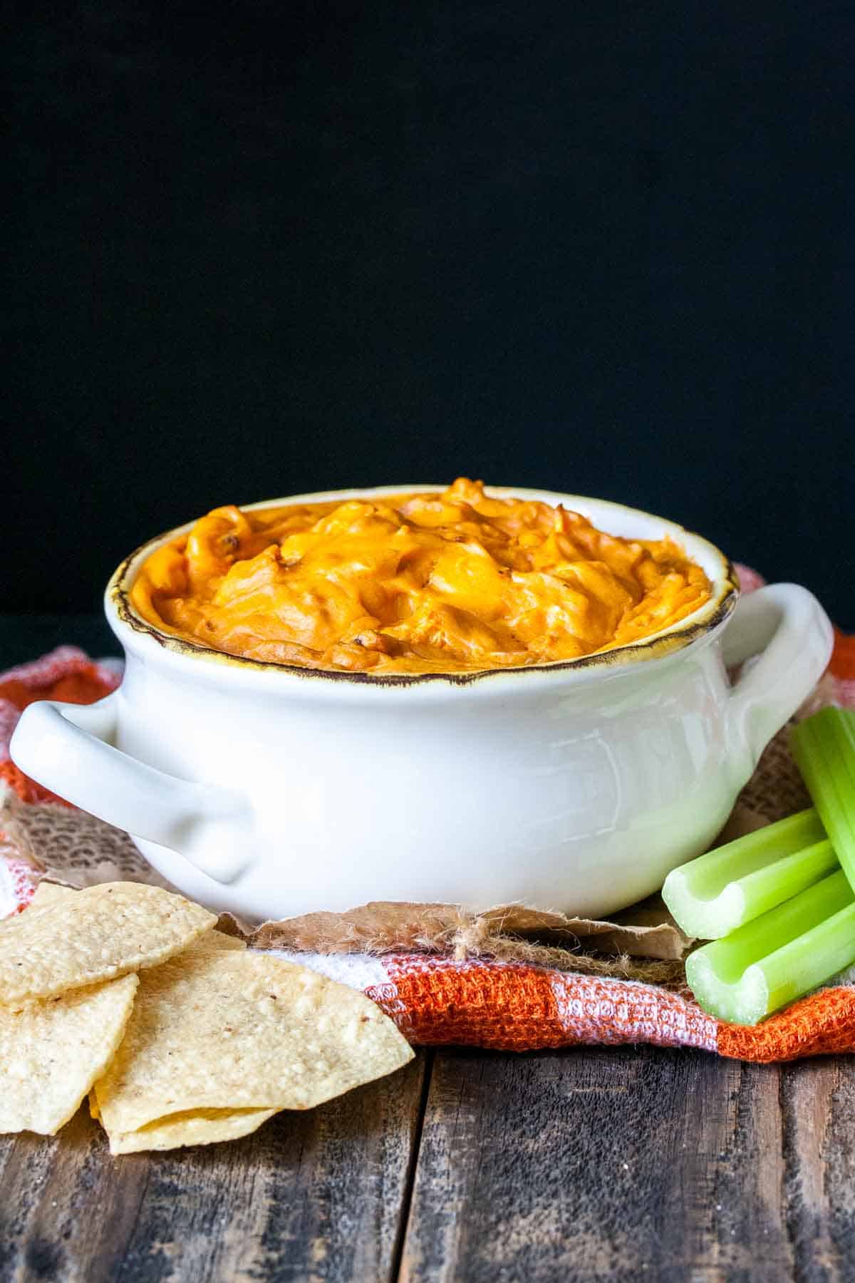 White soup bowl filled with baked buffalo dip