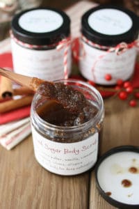 A knife getting out a scoop of homemade sugar scrub from a jar