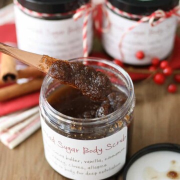 A knife getting out a scoop of homemade sugar scrub from a jar