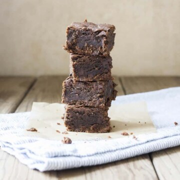 Pile of four brownies on a grey towel