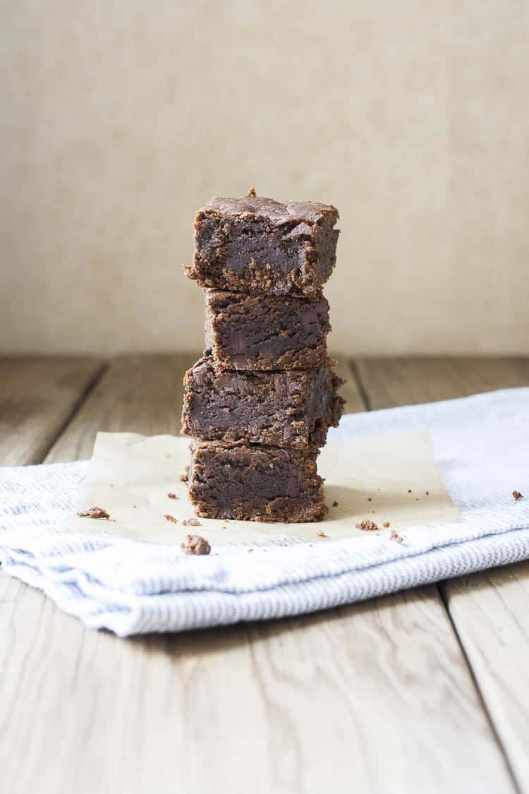 Pile of four brownies on a grey towel