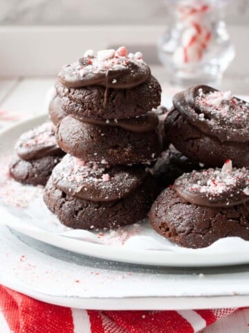 Pile of peppermint brownies on a white plate