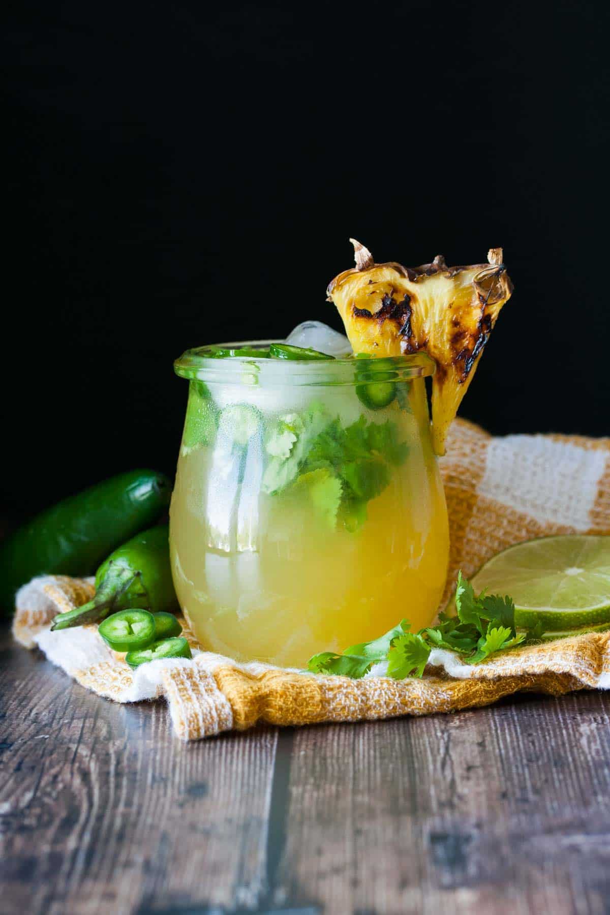 Glass with a pineapple jalapeno margarita inside