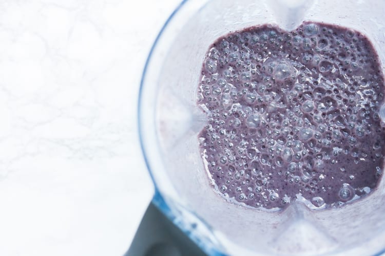 Top view of a purple drink in a blender