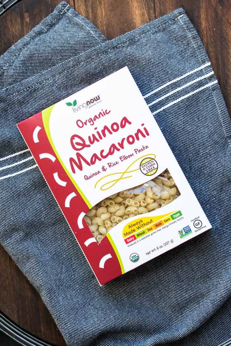 Top view of box of quinoa macaroni pasta on a grey towel