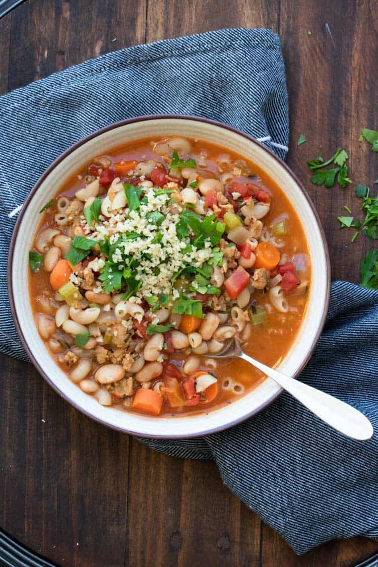 White bowl with pasta and vegetable bean soup inside