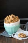 White bowl with raw cookie dough inside a turquoise bowl