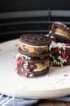 Two stacked cookie dough stuffed Oreos with chocolate and sprinkles