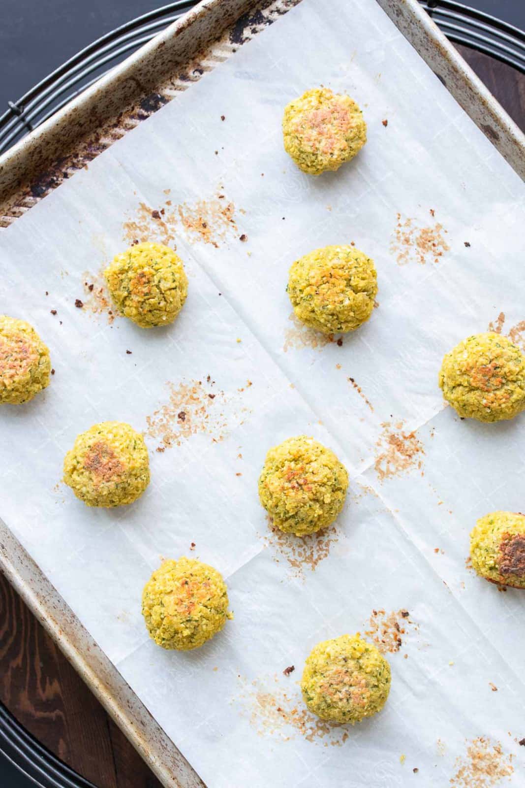 Baked falafel on a baking sheet lined with parchment paper