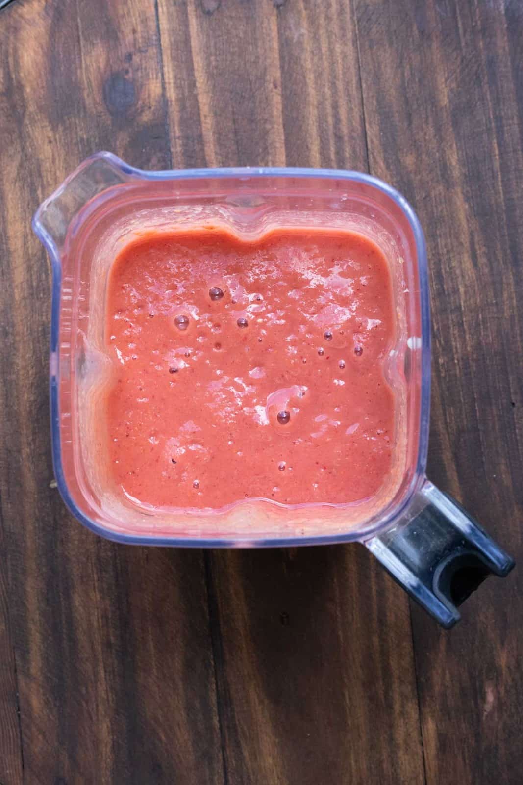 Top view of a pink smoothie in a blender