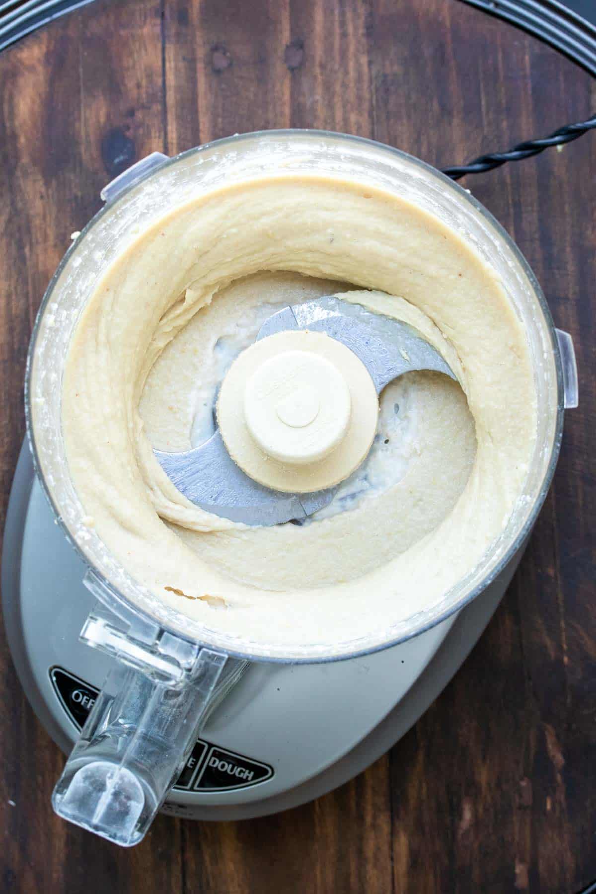 Top view of cashew cream cheese blended in a food processor.