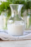 Glass carafe like jar filled half way with ranch dressing