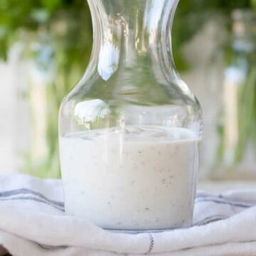 Glass carafe like jar filled half way with ranch dressing