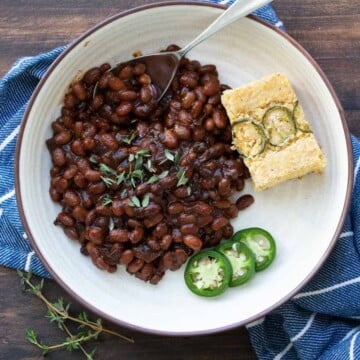 Cream plate with baked beans, jalapeno slices and cornbread