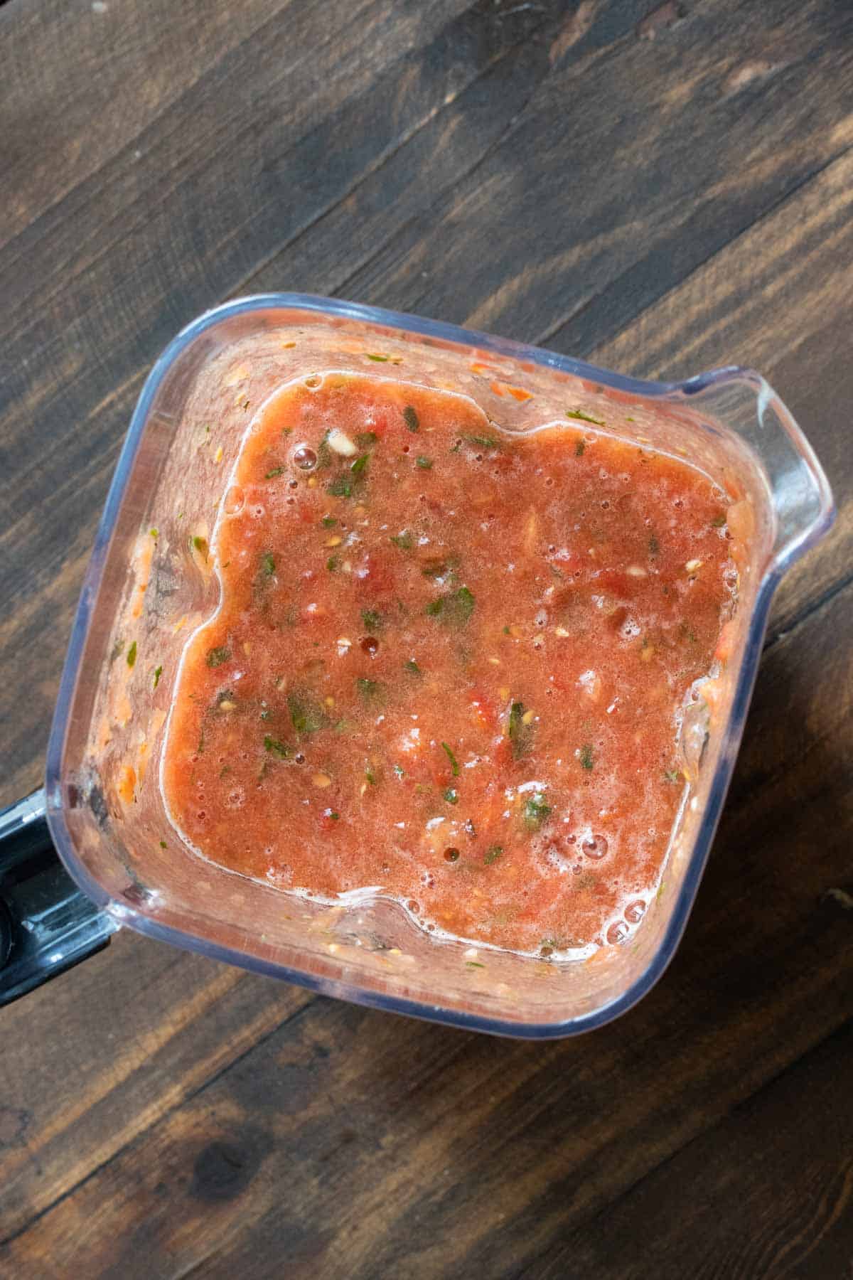 Top view of blender with pureed marinara sauce